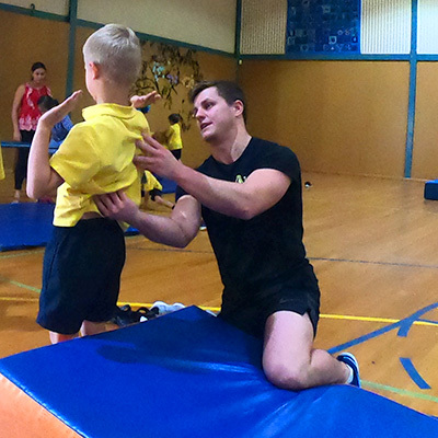 proactivity-gymnastics-coach-helping-student
